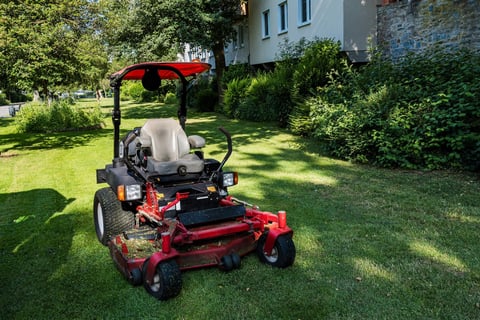 Riding mower on freshly cut grass